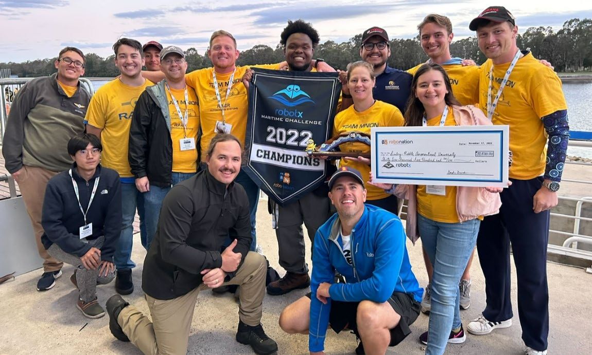 Team Minion with the 2022 Maritime RobotX Challenge champions banner